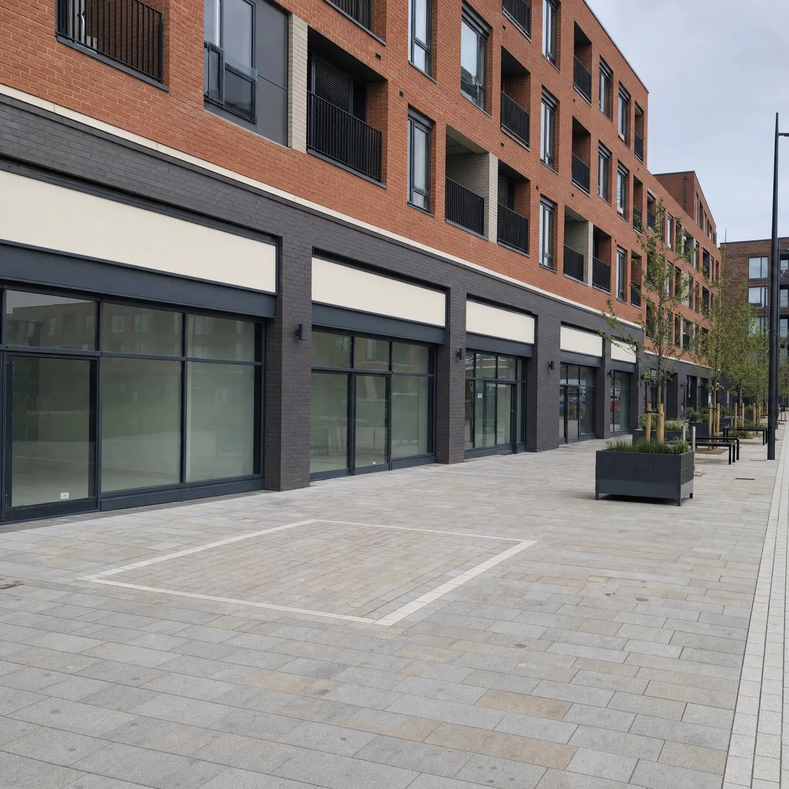 UK mixed-use development with ground-floor retail under a residential block