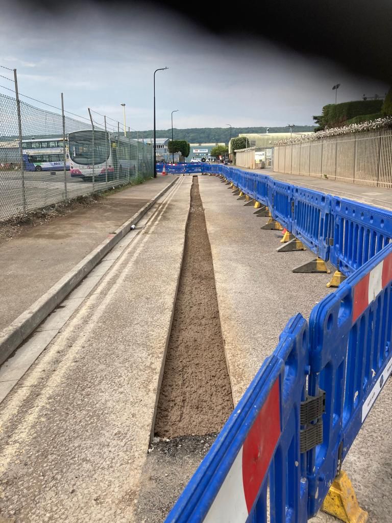 HGV-trafficked service yard with heavy-duty bituminous surface course being laid
